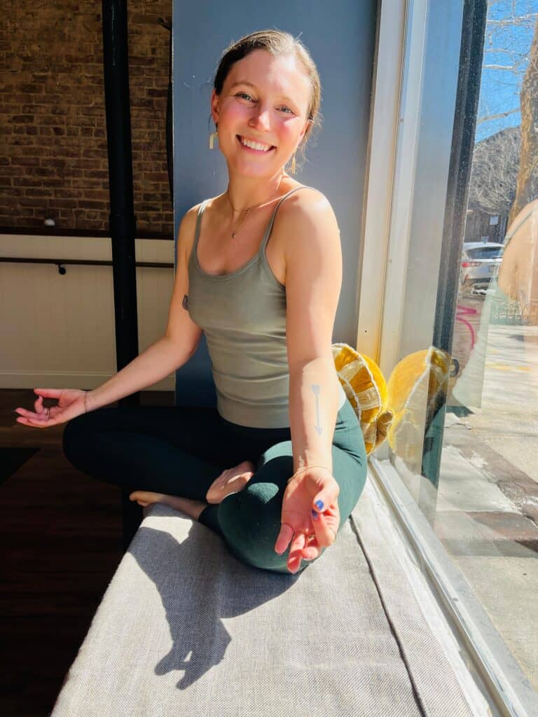 Meditating woman in a peaceful yoga studio, promoting mindfulness and wellness in Bedstuy.