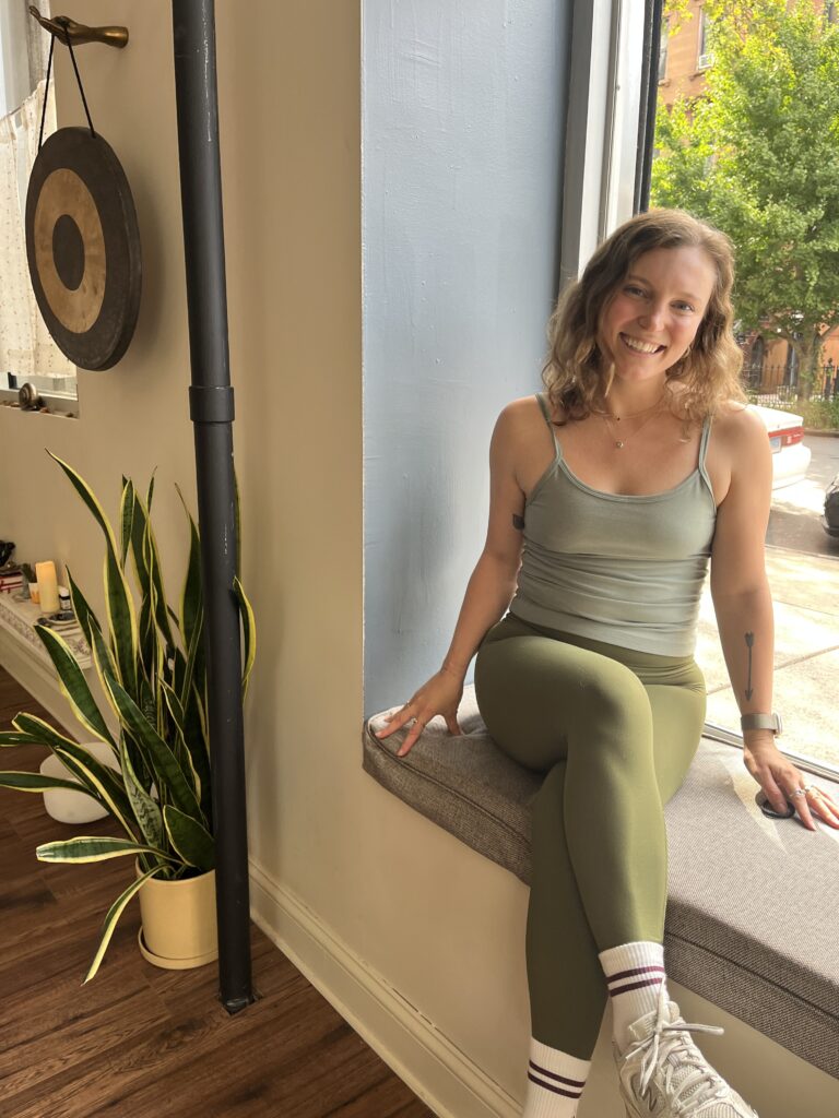 Serene woman practicing yoga at Bedstuy Yoga studio in Brooklyn, focusing on mindfulness and flexibility.