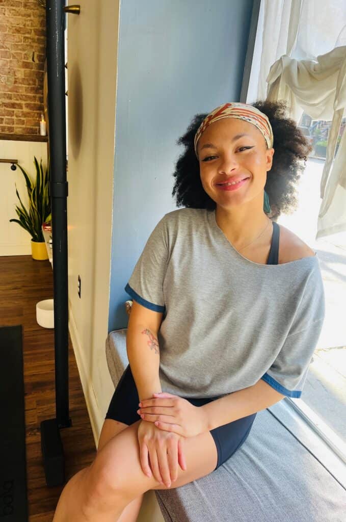 Najal Judd smiling during yoga session at Bedstuy Yoga studio.