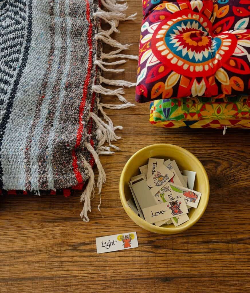 Colorful yoga mats and tarot cards on wooden floor for Bedstuy Yoga class.