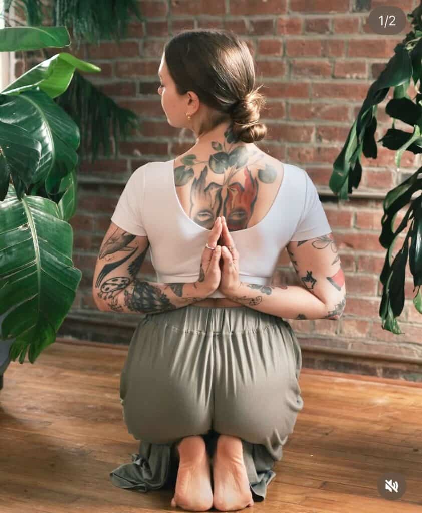 Meditation yoga pose with tattoos at Bedstuy Yoga studio.