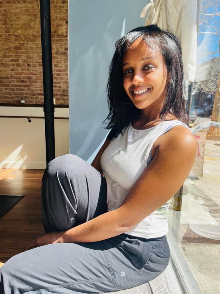 Yoga instructor practicing seated stretch at Bedstuy Yoga, Brooklyn.